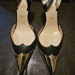 Gorgeous Christian Louboutin black with gold tip heel